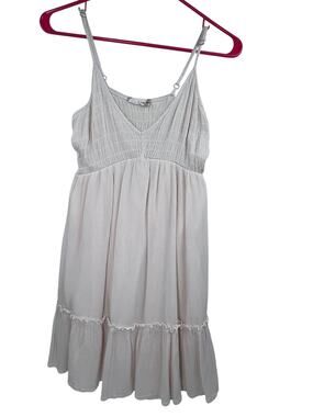 Cream-colored smocked mini dress from Altar'd State